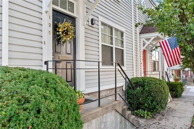a view of a house with brick walls and potted plants