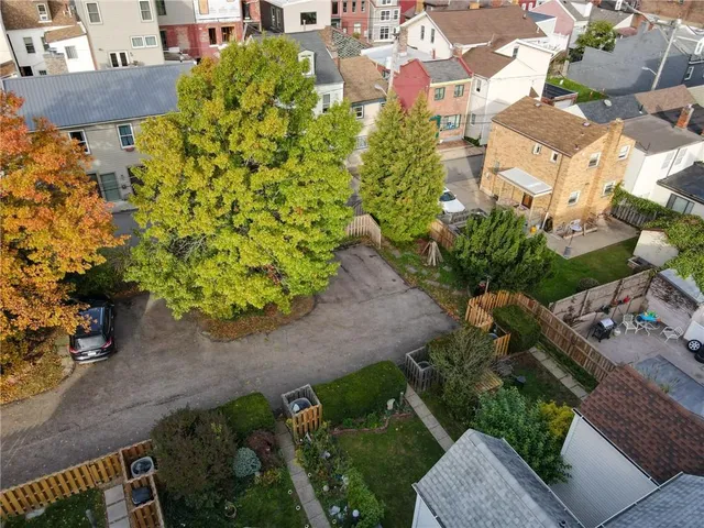 a aerial view of a house with a yard and potted plants