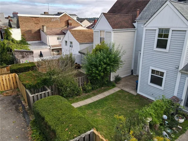an aerial view of a house with a yard