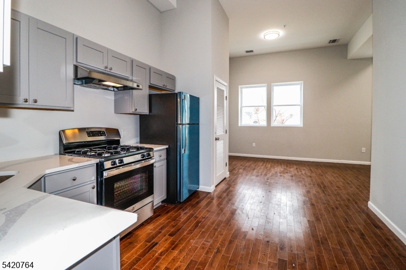 33 2nd Street, Unit 11 Raritan, NJ 08869 - Photo 2 of 7 a kitchen with stainless steel appliances granite countertop a stove a refrigerator and wooden floor