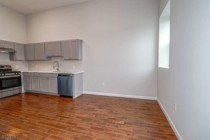 33 2nd Street, Unit 11 Raritan, NJ 08869 - Photo 3 of 7 a view of kitchen with wooden floor and electronic appliances