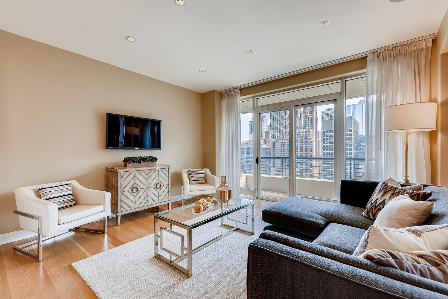 270 East Pearson Street, Unit 1402 Chicago, IL 60611 - Photo 13 of 34 a living room with furniture and a flat screen tv