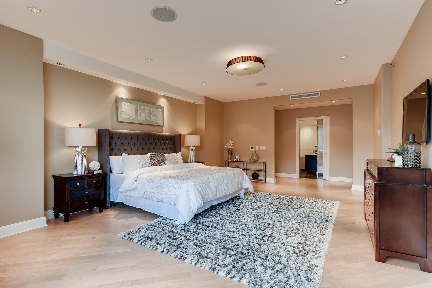 270 East Pearson Street, Unit 1402 Chicago, IL 60611 - Photo 18 of 34 a bedroom with a bed and wooden floor