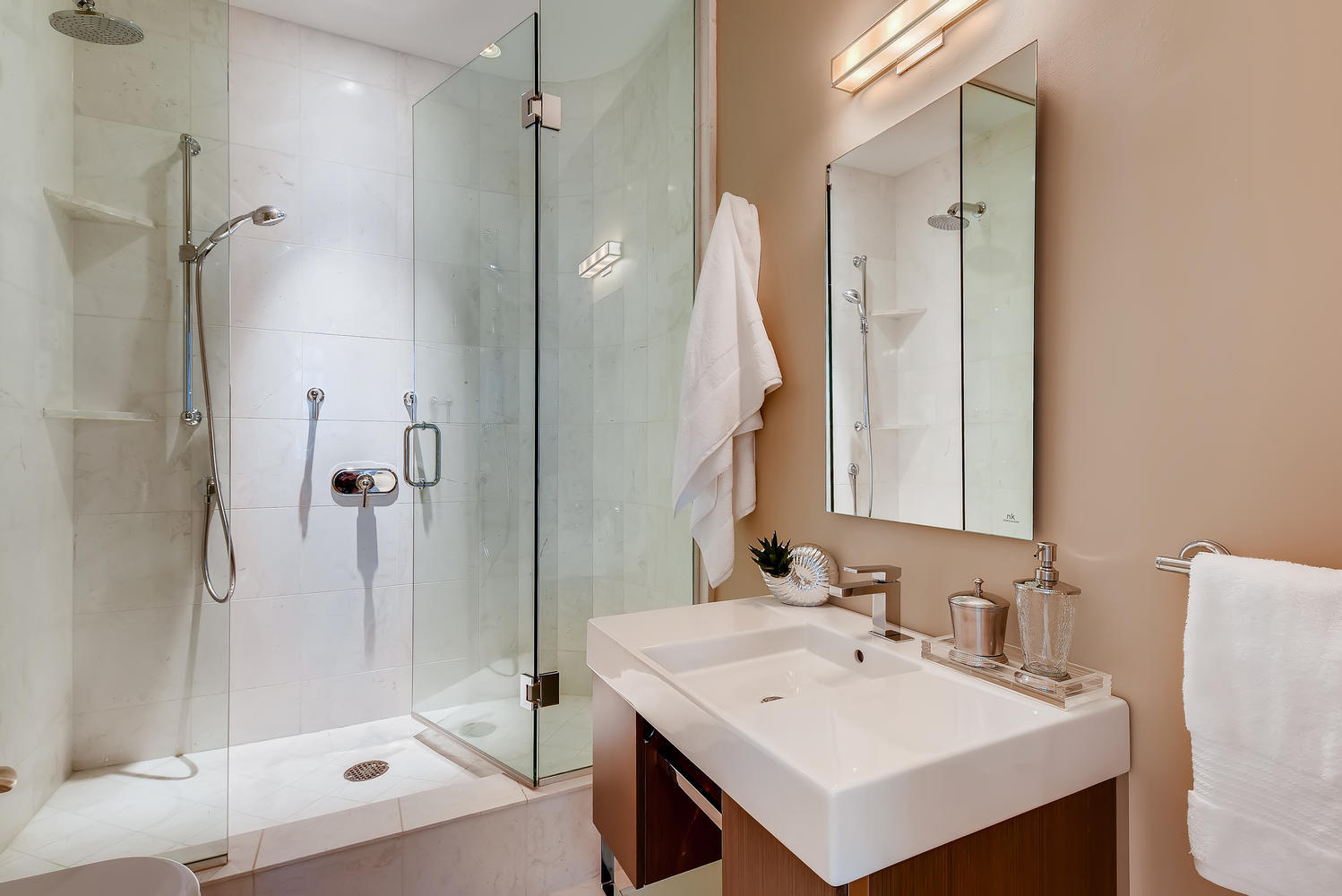 270 East Pearson Street, Unit 1402 Chicago, IL 60611 - Photo 29 of 34 a bathroom with a sink mirror and a shower