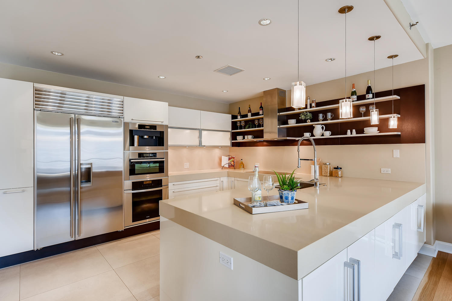 270 East Pearson Street, Unit 1402 Chicago, IL 60611 - Photo 8 of 34 a kitchen with stainless steel appliances a sink and a refrigerator