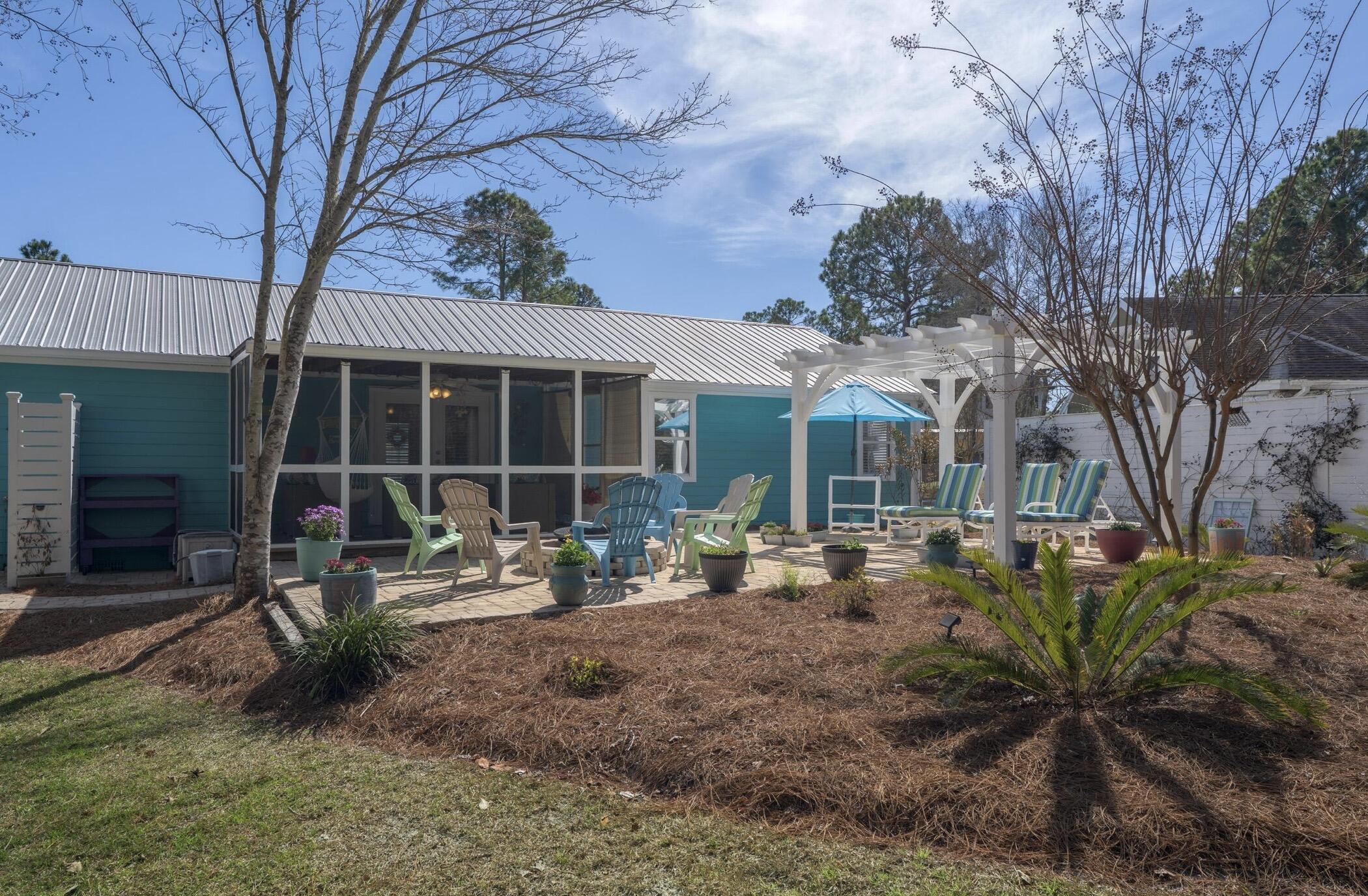 237 Monarch Drive Santa Rosa Beach, FL 32459 - Photo 2 of 30 a front view of a house with garden and porch
