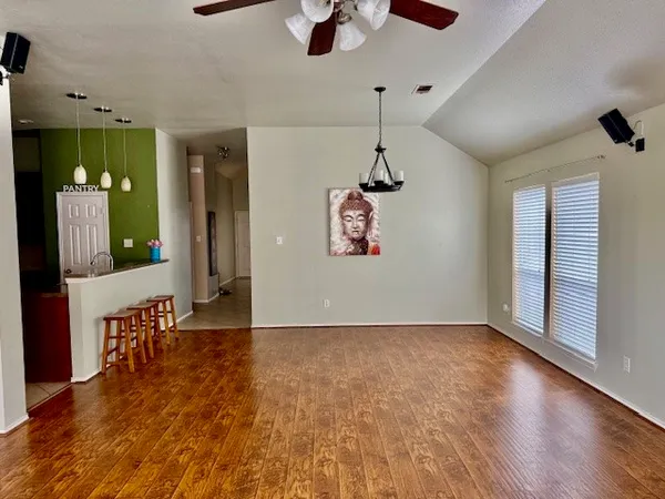 wooden floor in an empty room with a window