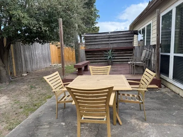 a view of a patio with a table and chairs