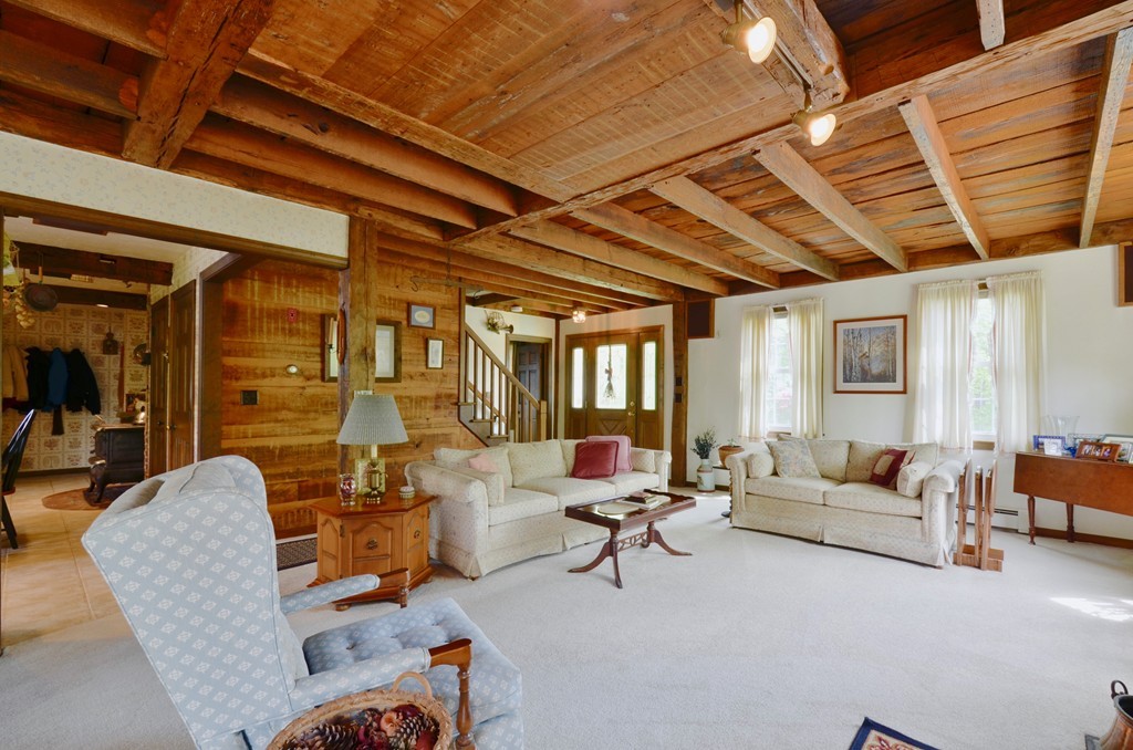 41 Rawson Road Webster, MA 01570 - Photo 12 of 30 a living room with furniture and a chandelier
