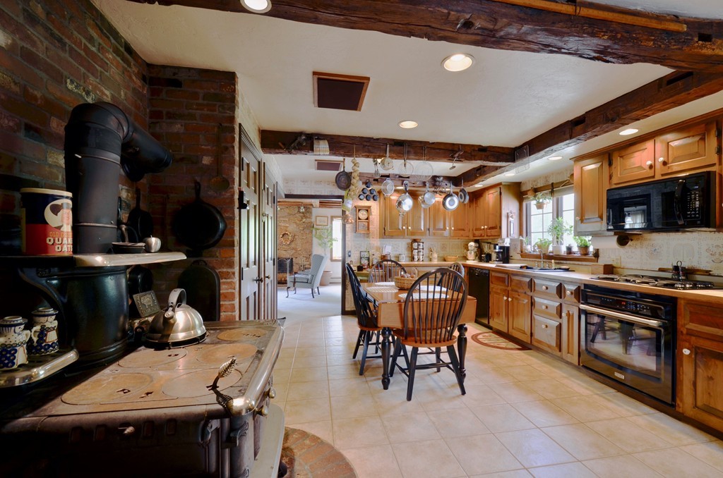 41 Rawson Road Webster, MA 01570 - Photo 21 of 30 a kitchen with a table chairs and a stove