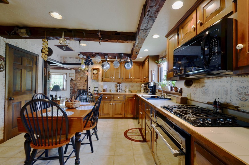41 Rawson Road Webster, MA 01570 - Photo 22 of 30 a kitchen with a table chairs and a stove