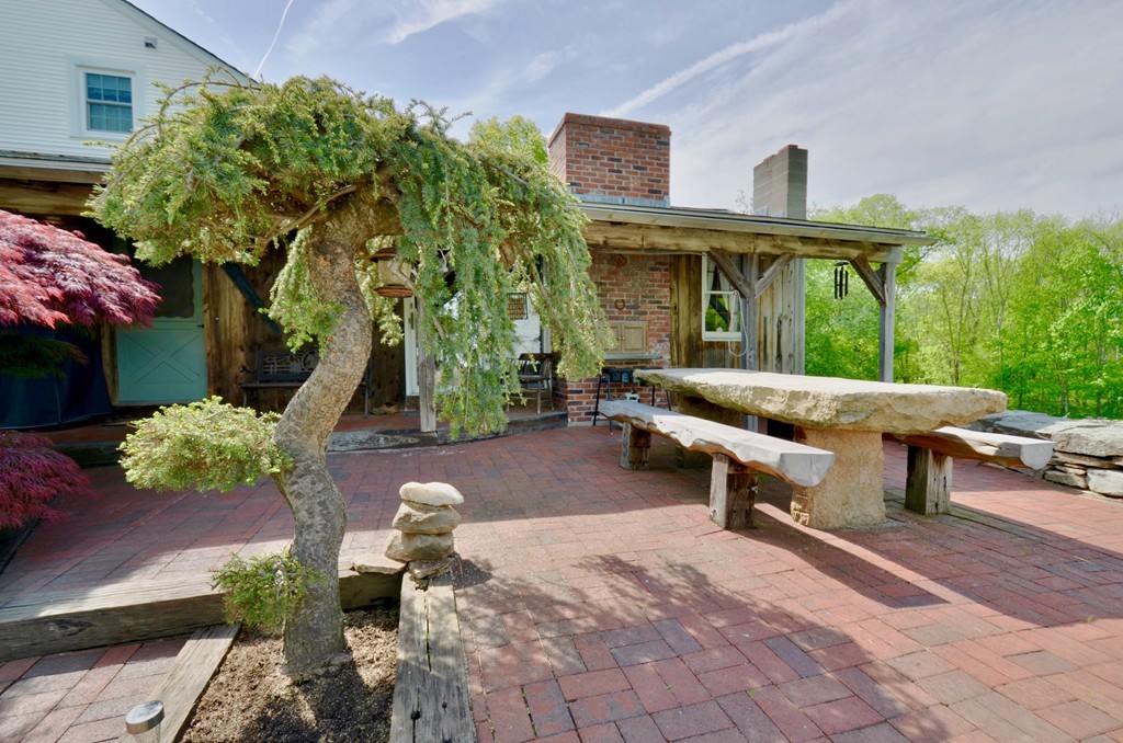 41 Rawson Road Webster, MA 01570 - Photo 6 of 30 a backyard of a house with yard fountain and outdoor seating