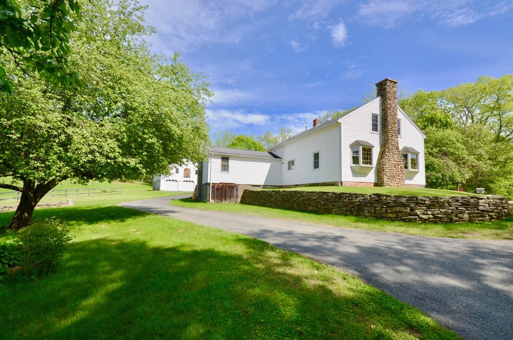 41 Rawson Road Webster, MA 01570 - Photo 10 of 30 a front view of a house with a yard and garage