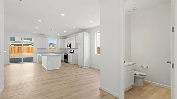 a view of a kitchen and dining room with a sink