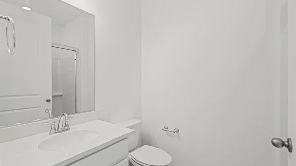 a bathroom with a sink toilet and vanity