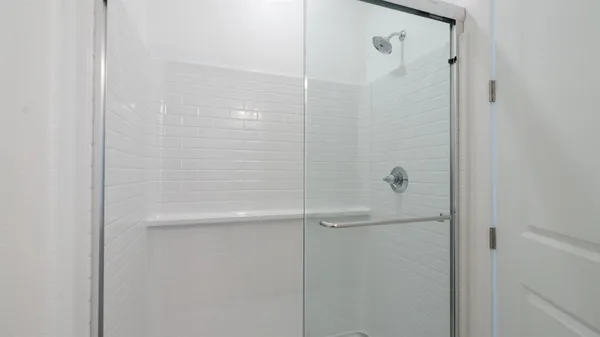 a bathroom with a glass shower door