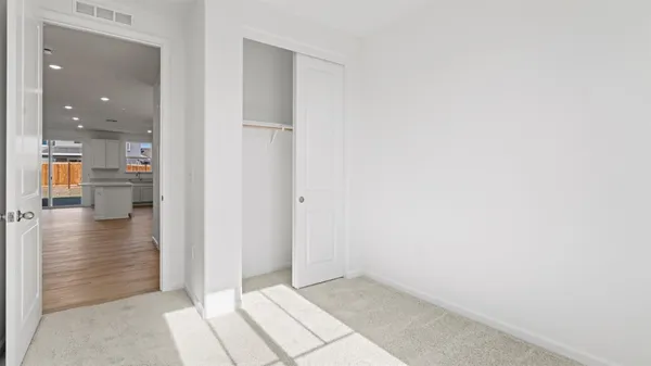 a view of a hallway with a kitchen space