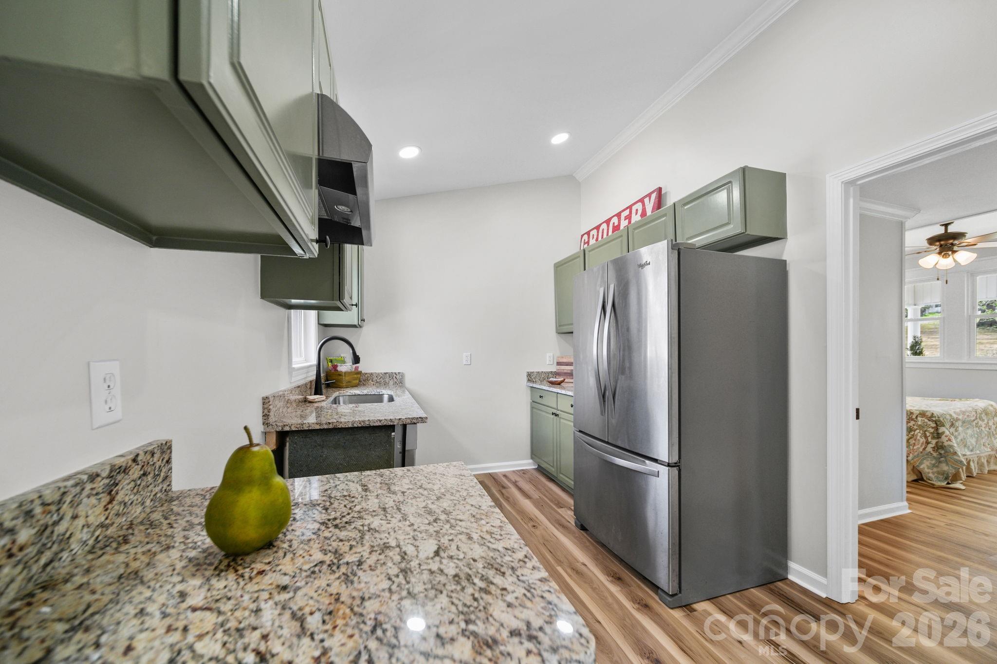 196 Spruce Street Badin, NC 28009 - Photo 11 of 43 a kitchen with stainless steel appliances granite countertop a refrigerator and a sink