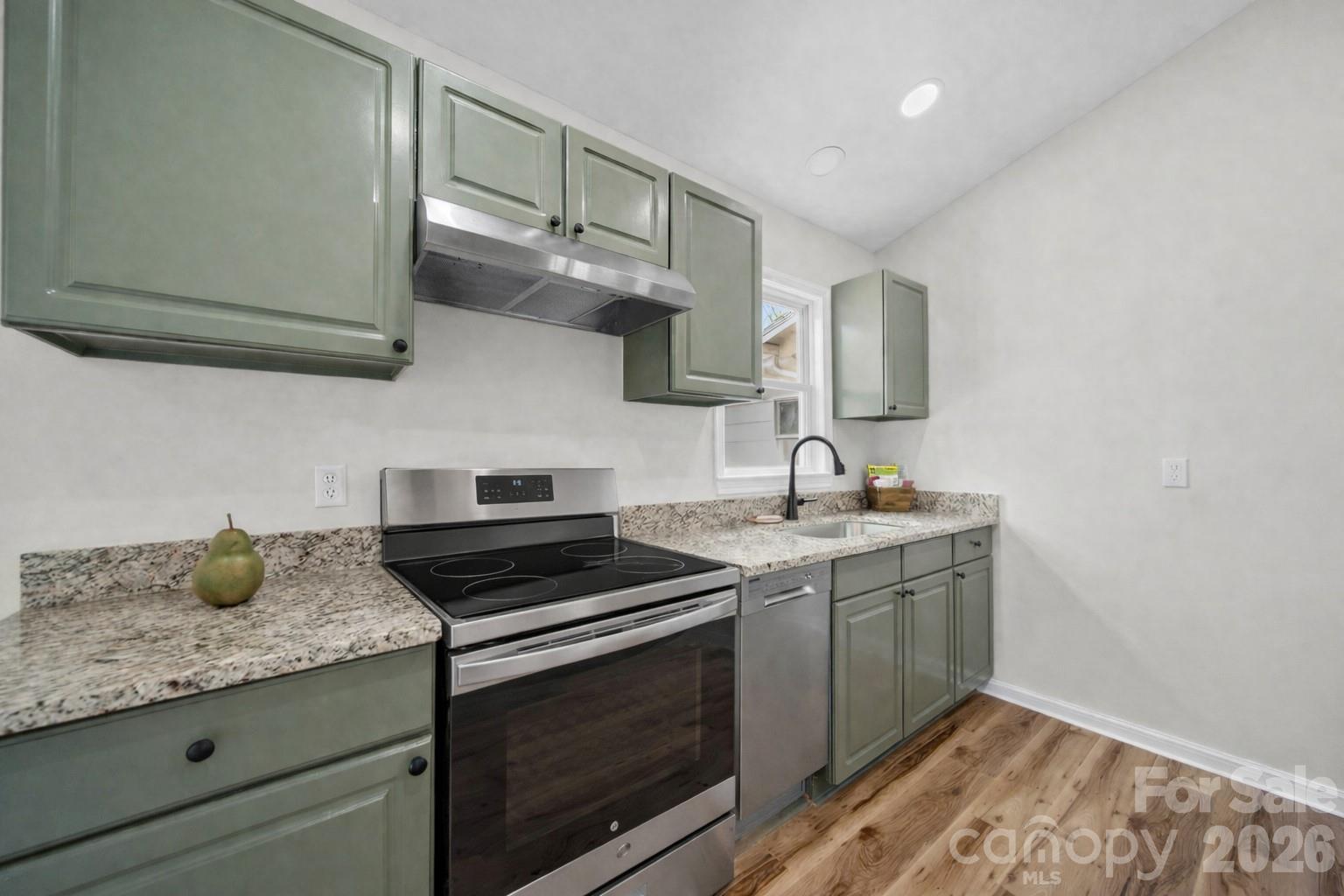 196 Spruce Street Badin, NC 28009 - Photo 13 of 43 a kitchen with stainless steel appliances granite countertop a sink stove and cabinets