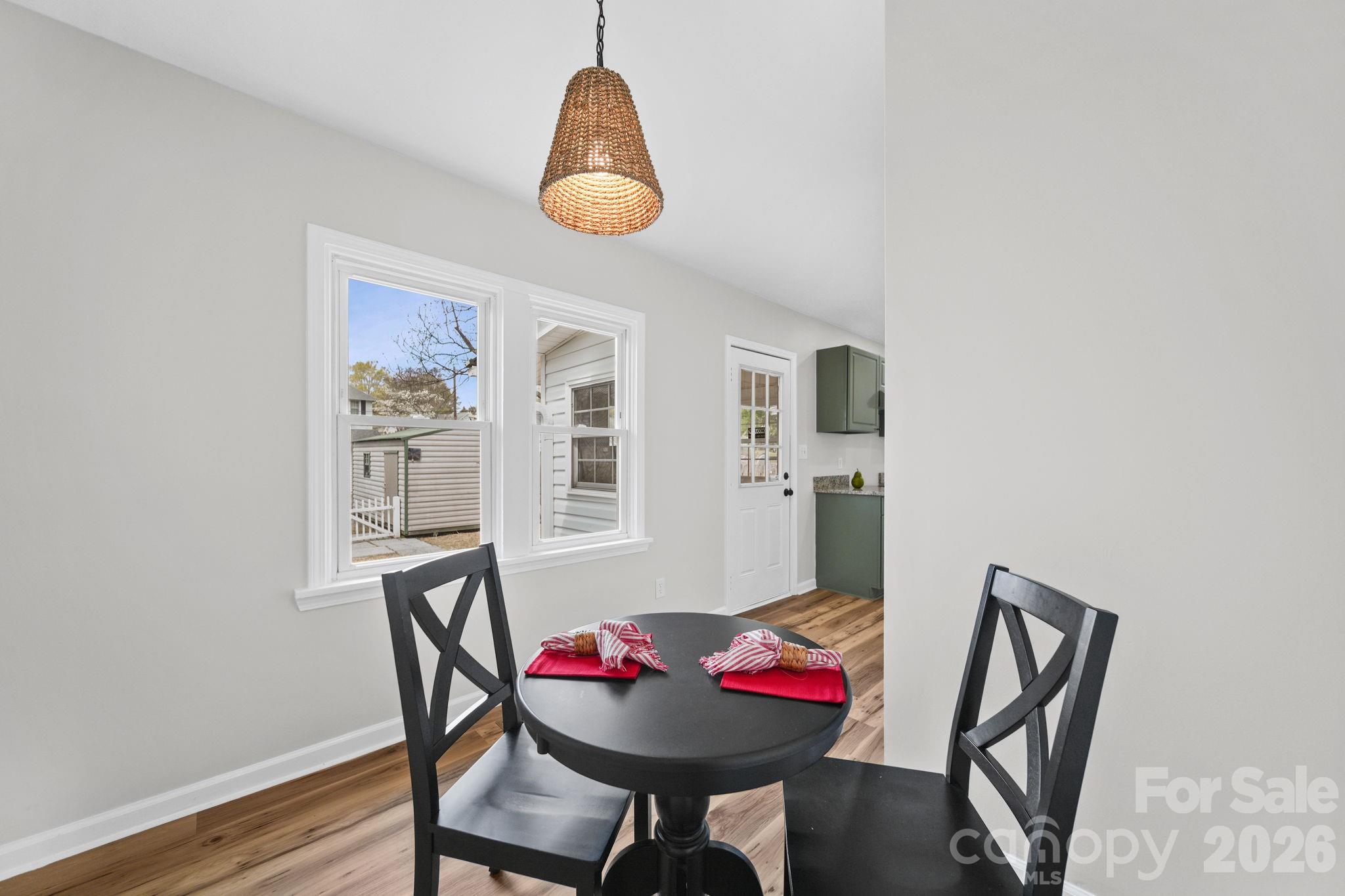196 Spruce Street Badin, NC 28009 - Photo 17 of 43 a view of a dining room with furniture and wooden floor