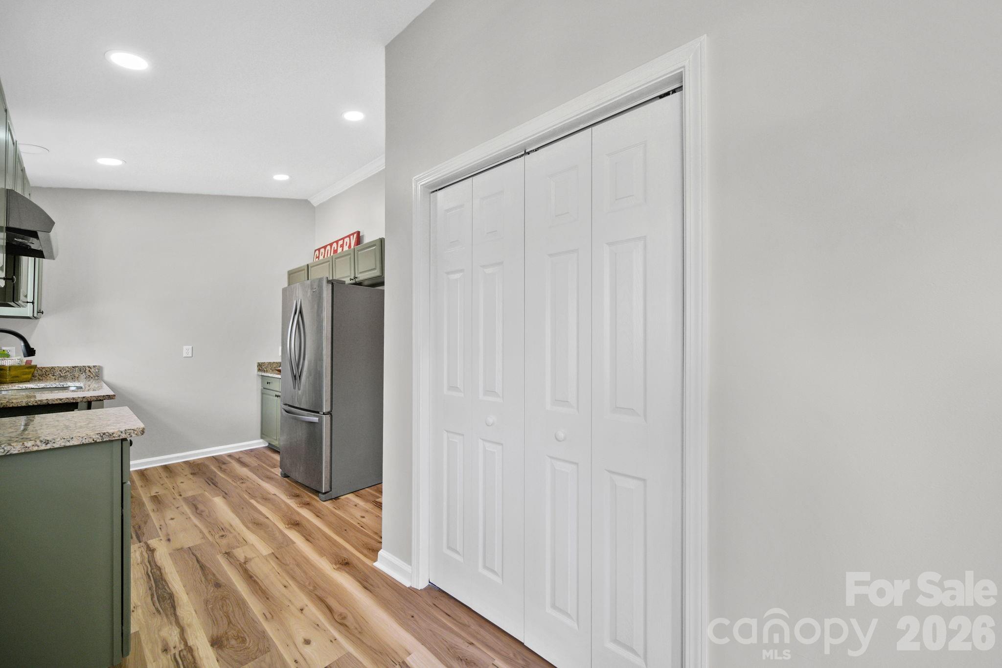 196 Spruce Street Badin, NC 28009 - Photo 19 of 43 a view of a refrigerator in kitchen and wooden floor