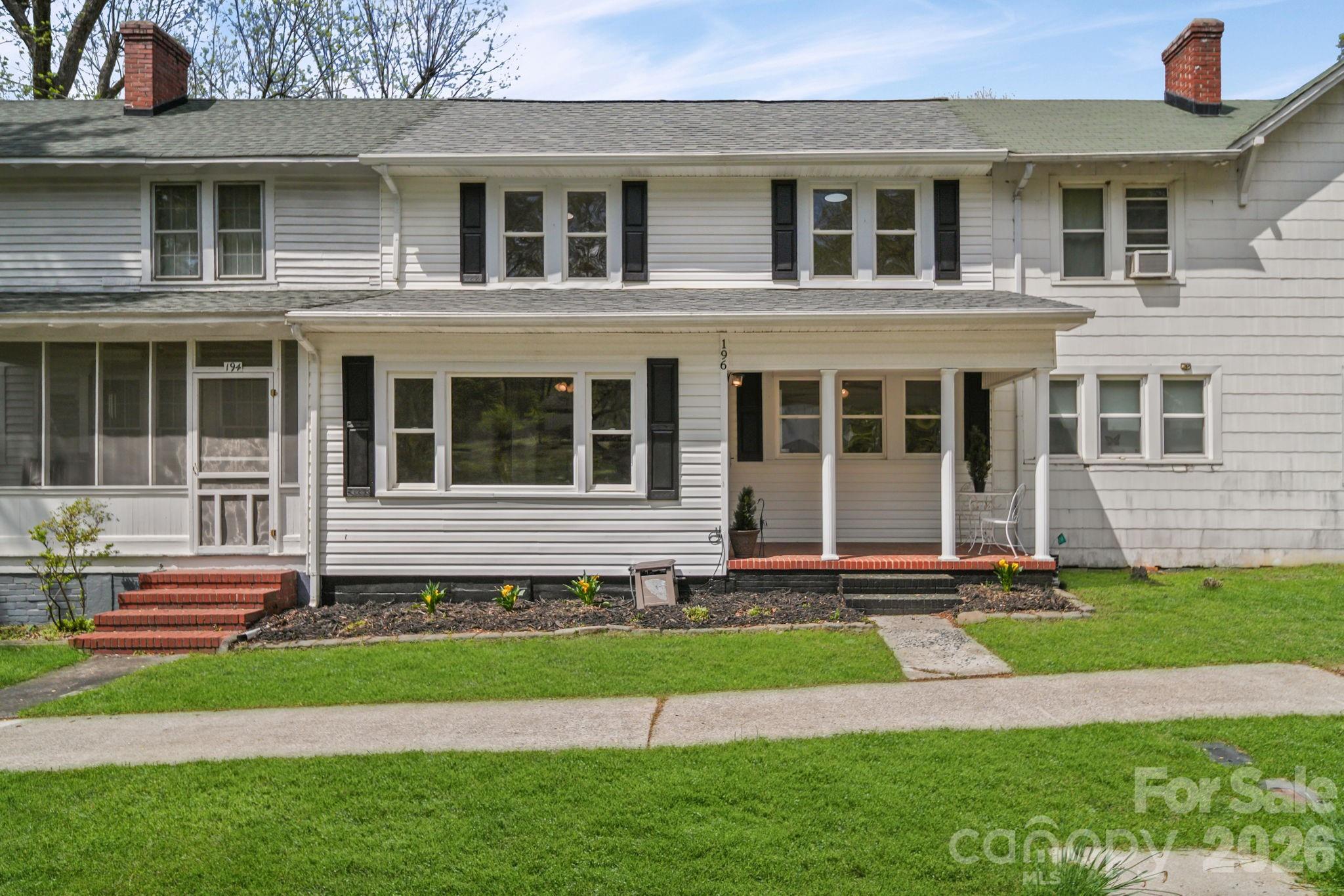 196 Spruce Street Badin, NC 28009 - Photo 2 of 43 a house that has a garden in front of it