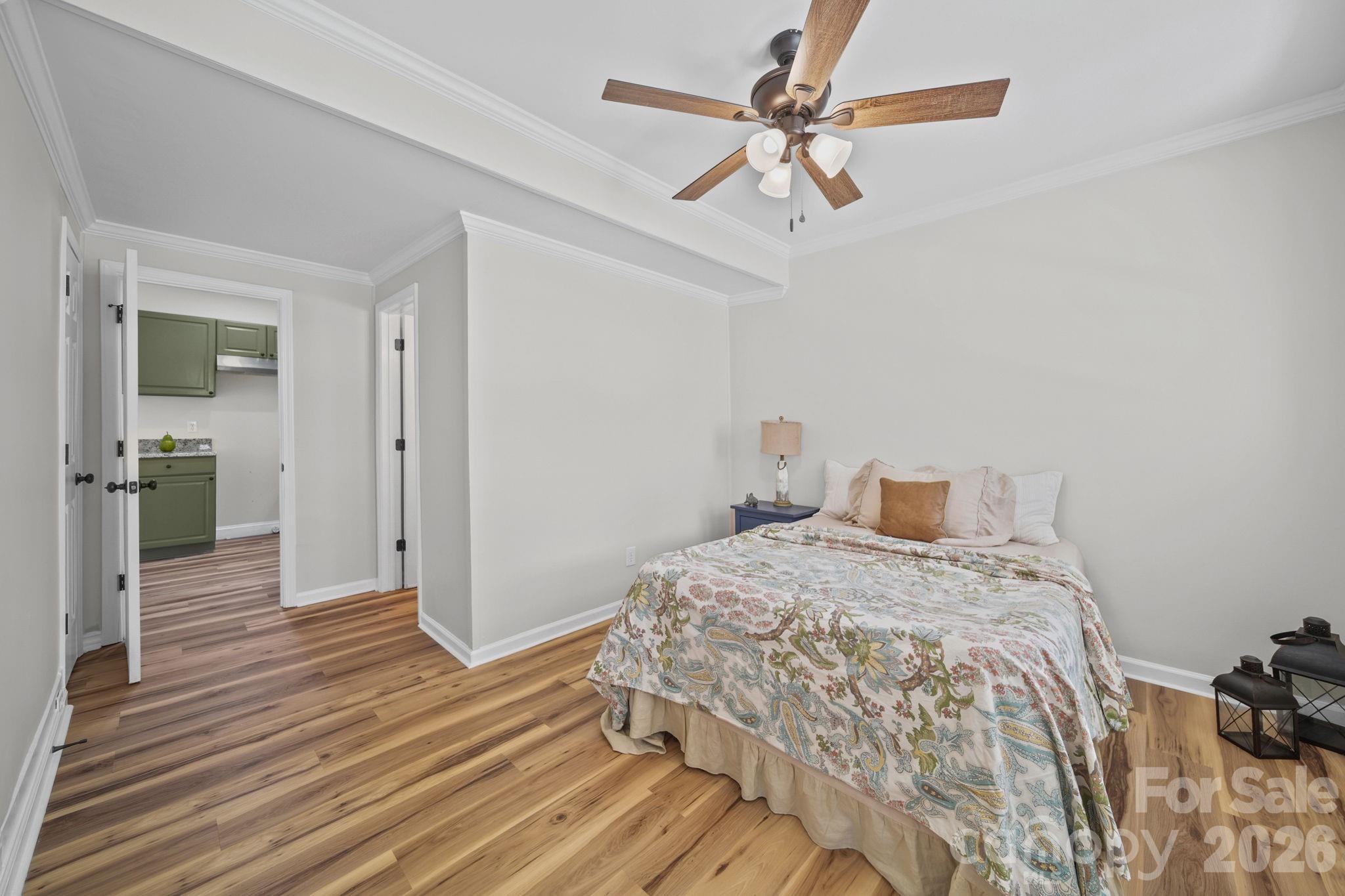 196 Spruce Street Badin, NC 28009 - Photo 21 of 43 a bedroom with a bed and a chandelier