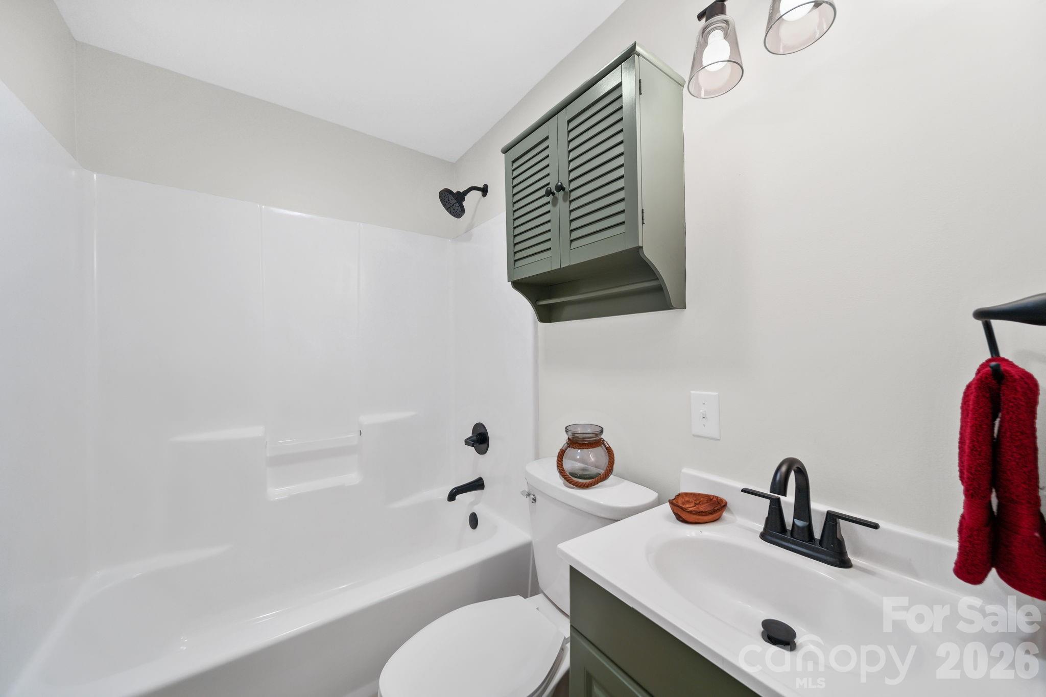196 Spruce Street Badin, NC 28009 - Photo 23 of 43 a bathroom with a sink toilet a mirror and shower