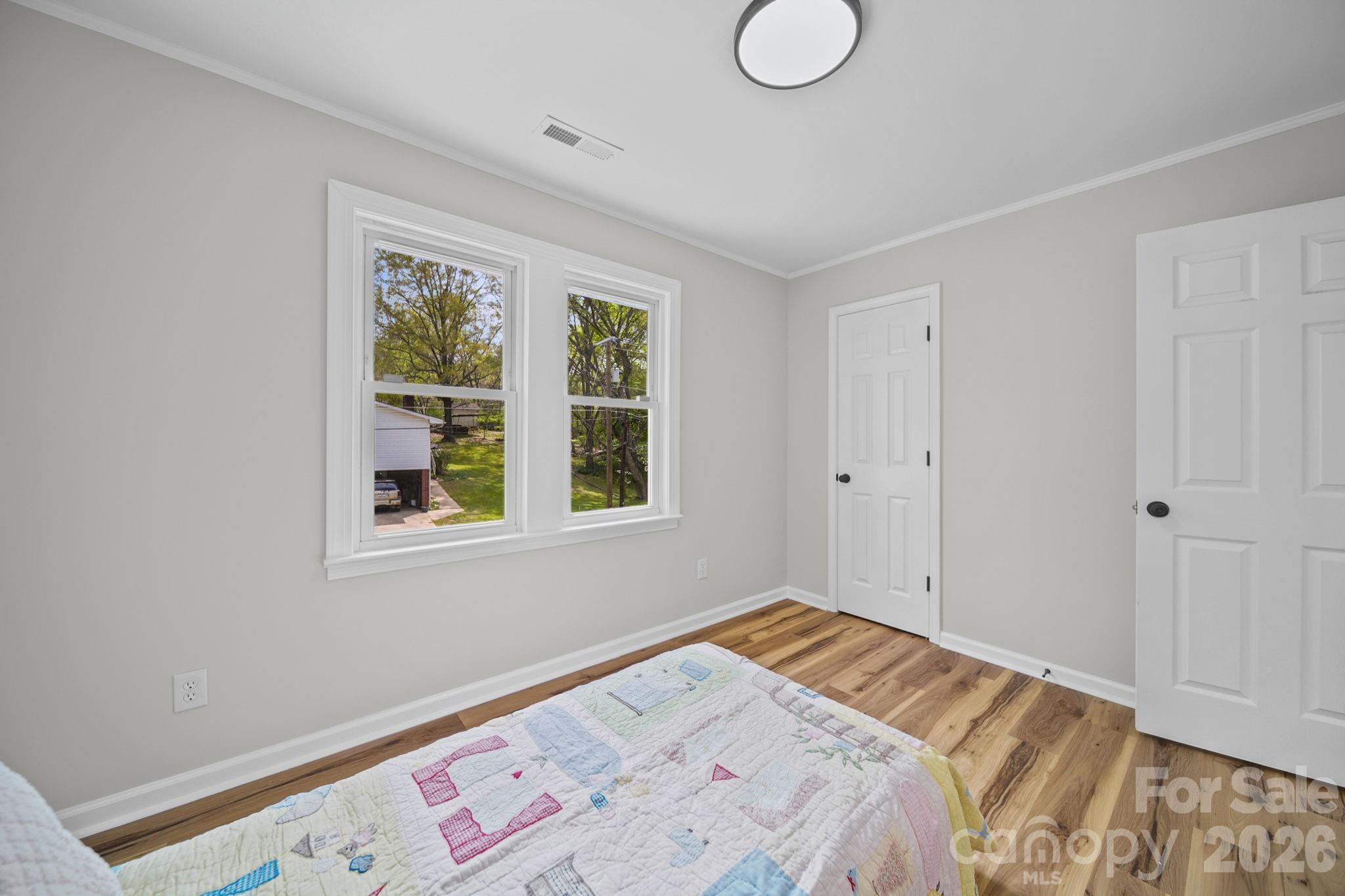 196 Spruce Street Badin, NC 28009 - Photo 26 of 43 a bedroom with a bed and a window