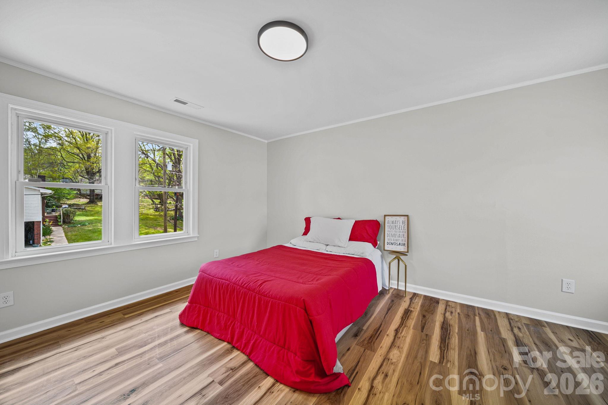 196 Spruce Street Badin, NC 28009 - Photo 28 of 43 a bedroom with a bed and window