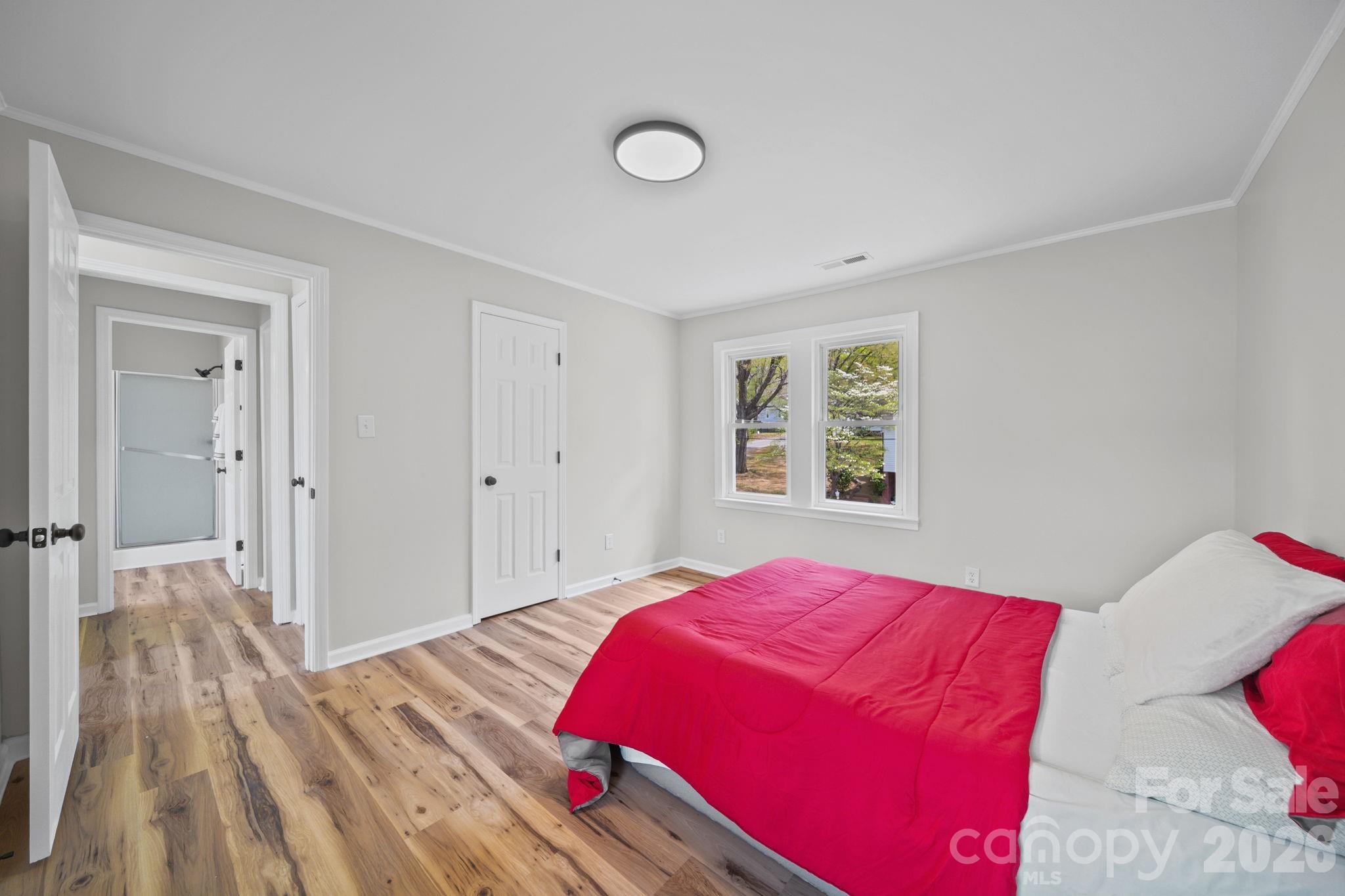 196 Spruce Street Badin, NC 28009 - Photo 29 of 43 a bedroom with a bed and wooden floor
