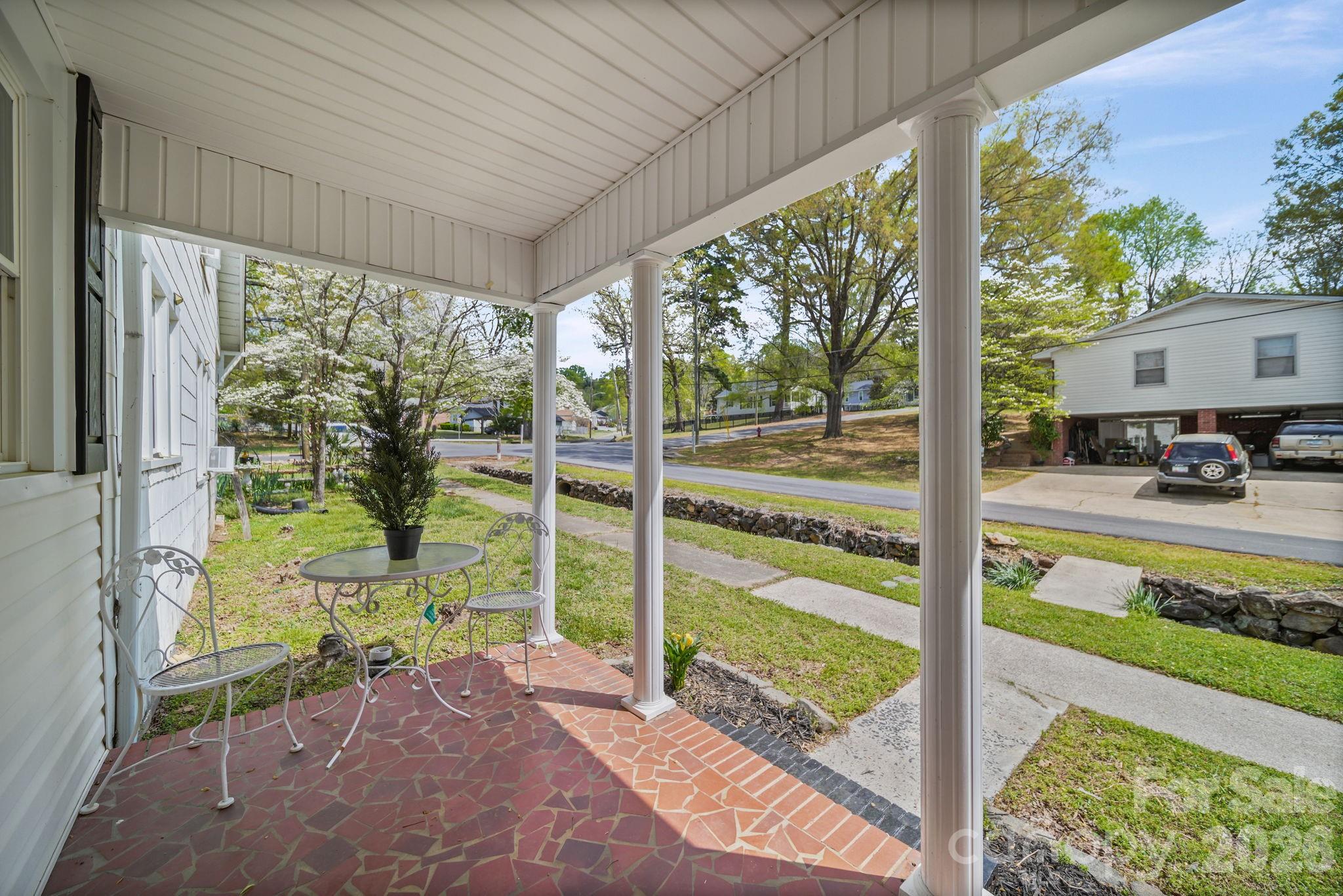 196 Spruce Street Badin, NC 28009 - Photo 4 of 43 a view of a porch with a floor to ceiling window and a yard