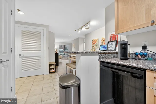 a kitchen with stainless steel appliances granite countertop a sink and a refrigerator