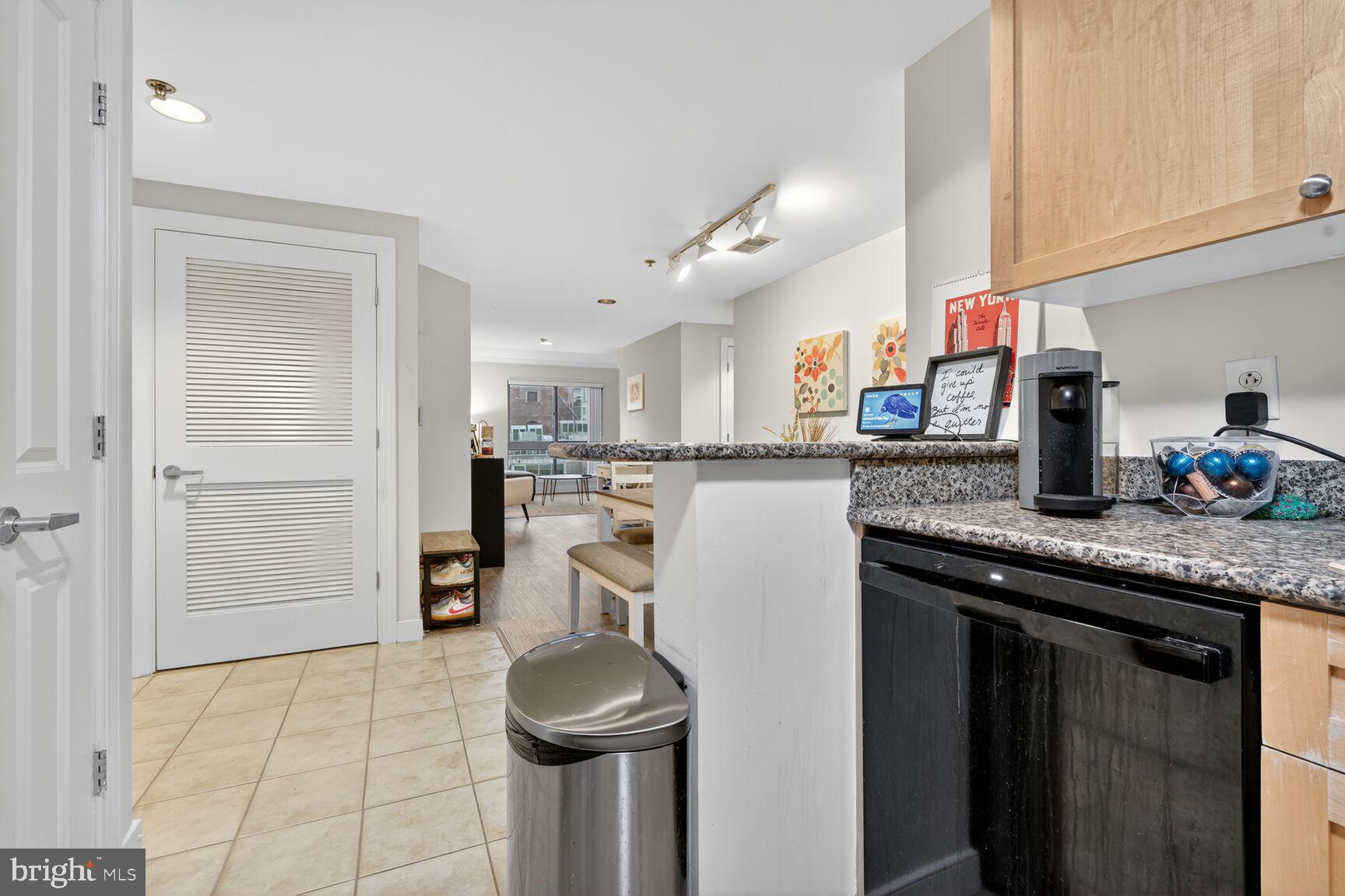 777 7th Street Northwest, Unit 526 Washington, DC 20001 - Photo 17 of 24 a kitchen with stainless steel appliances granite countertop a sink and a refrigerator