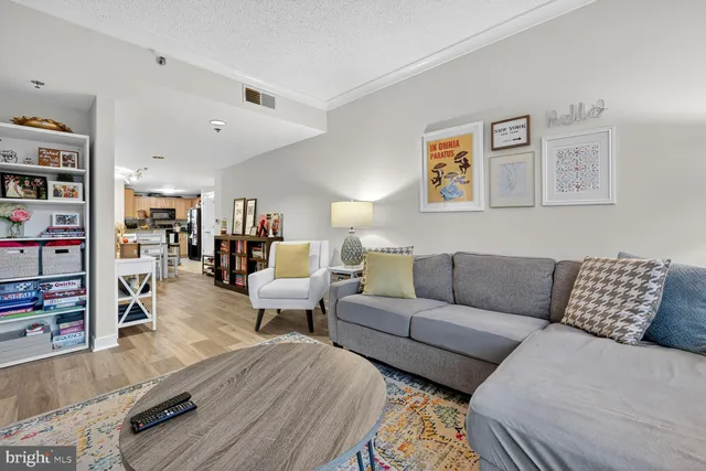 a living room with furniture and a book shelf
