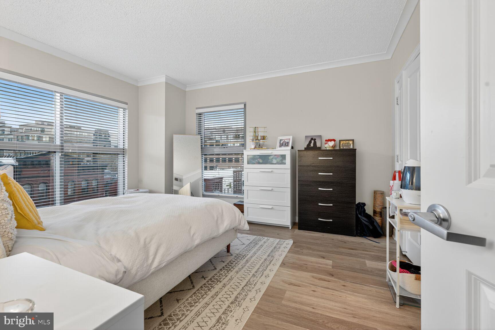 777 7th Street Northwest, Unit 526 Washington, DC 20001 - Photo 4 of 24 a bedroom with a bed and a window