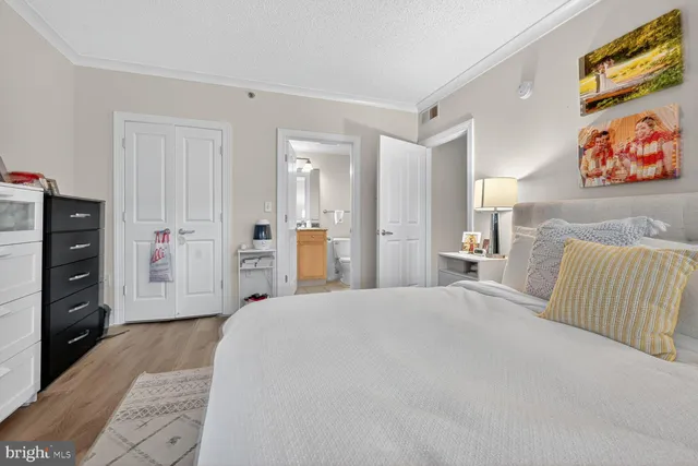 a large bedroom with a bed and a couch