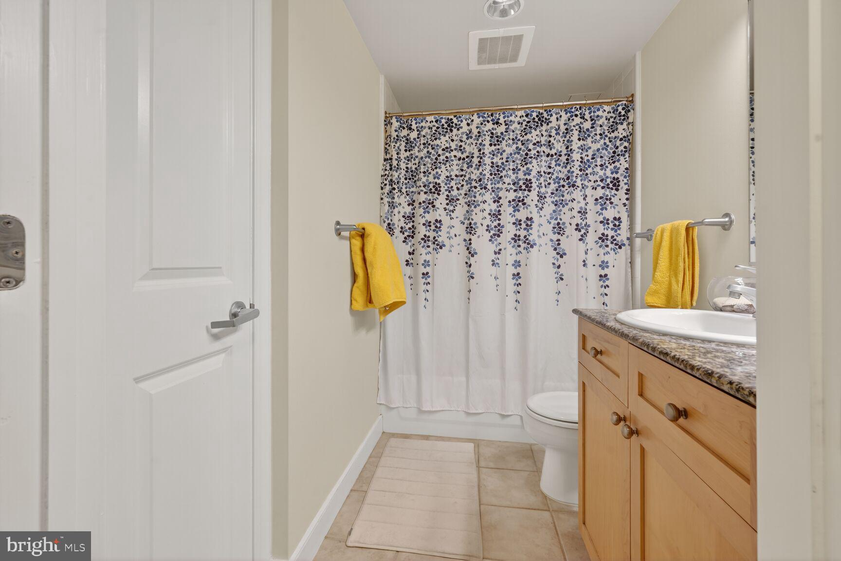 777 7th Street Northwest, Unit 526 Washington, DC 20001 - Photo 8 of 24 a bathroom with a granite countertop sink a vanity and a shower