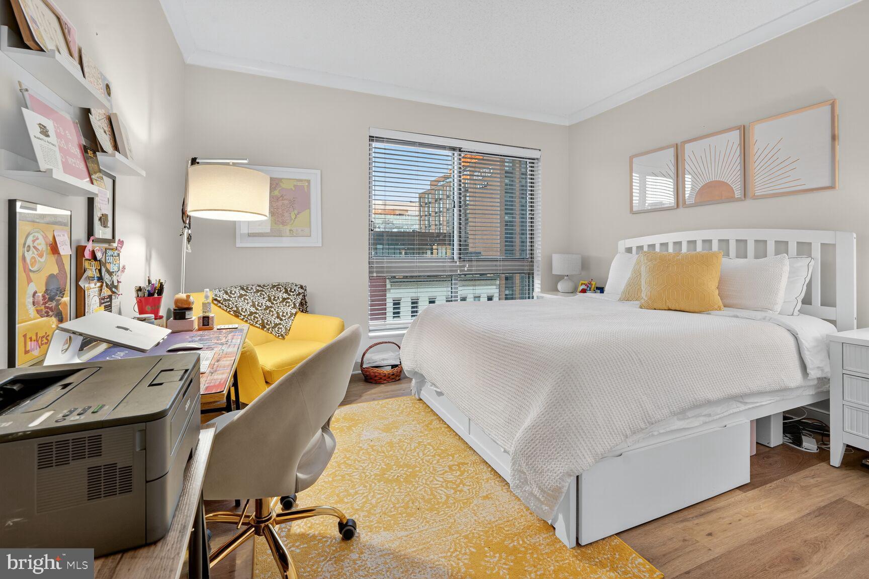 777 7th Street Northwest, Unit 526 Washington, DC 20001 - Photo 10 of 24 a bed room with a bed and a chair