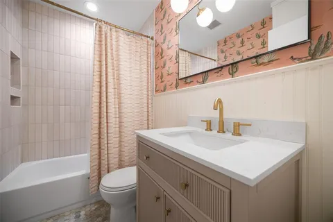 a bathroom with a sink a toilet and a bathtub