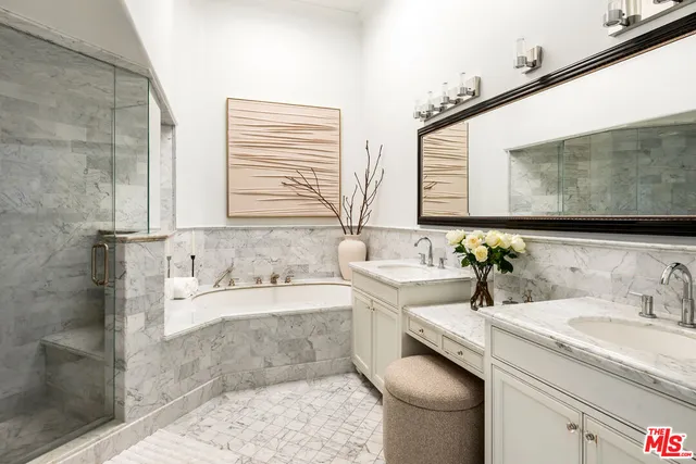 a bathroom with a granite countertop sink and a bathtub