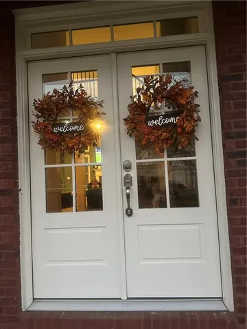 a view of a entryway door of the house and window