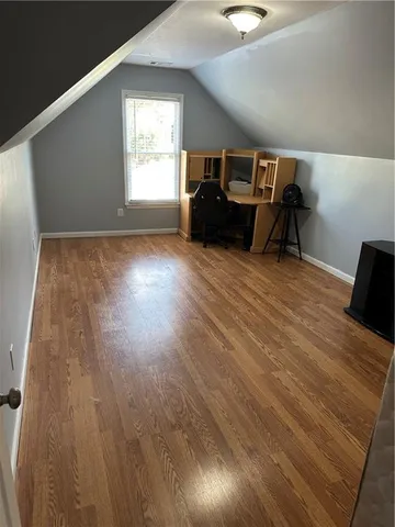 a room with wooden floor and windows