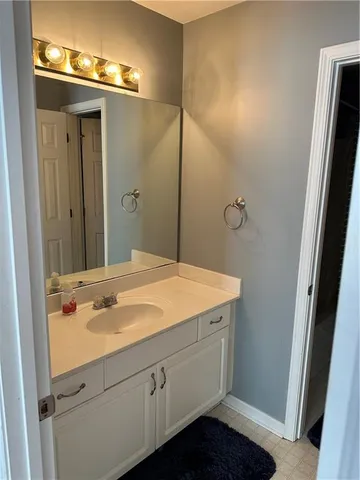 a bathroom with a sink and mirror