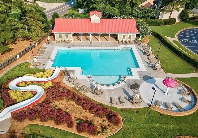 an aerial view of a tennis ground and a houses