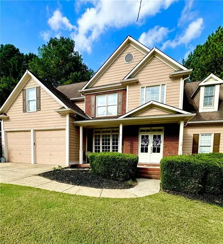 a front view of a house with a yard