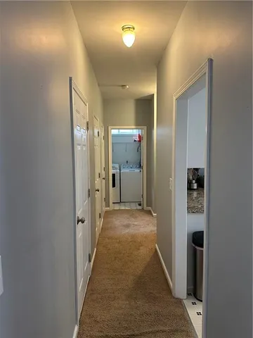 a view of hallway with wooden floor