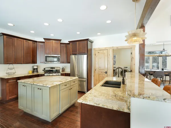 a kitchen with a sink stove and refrigerator