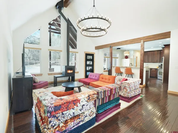 a living room with furniture and a chandelier