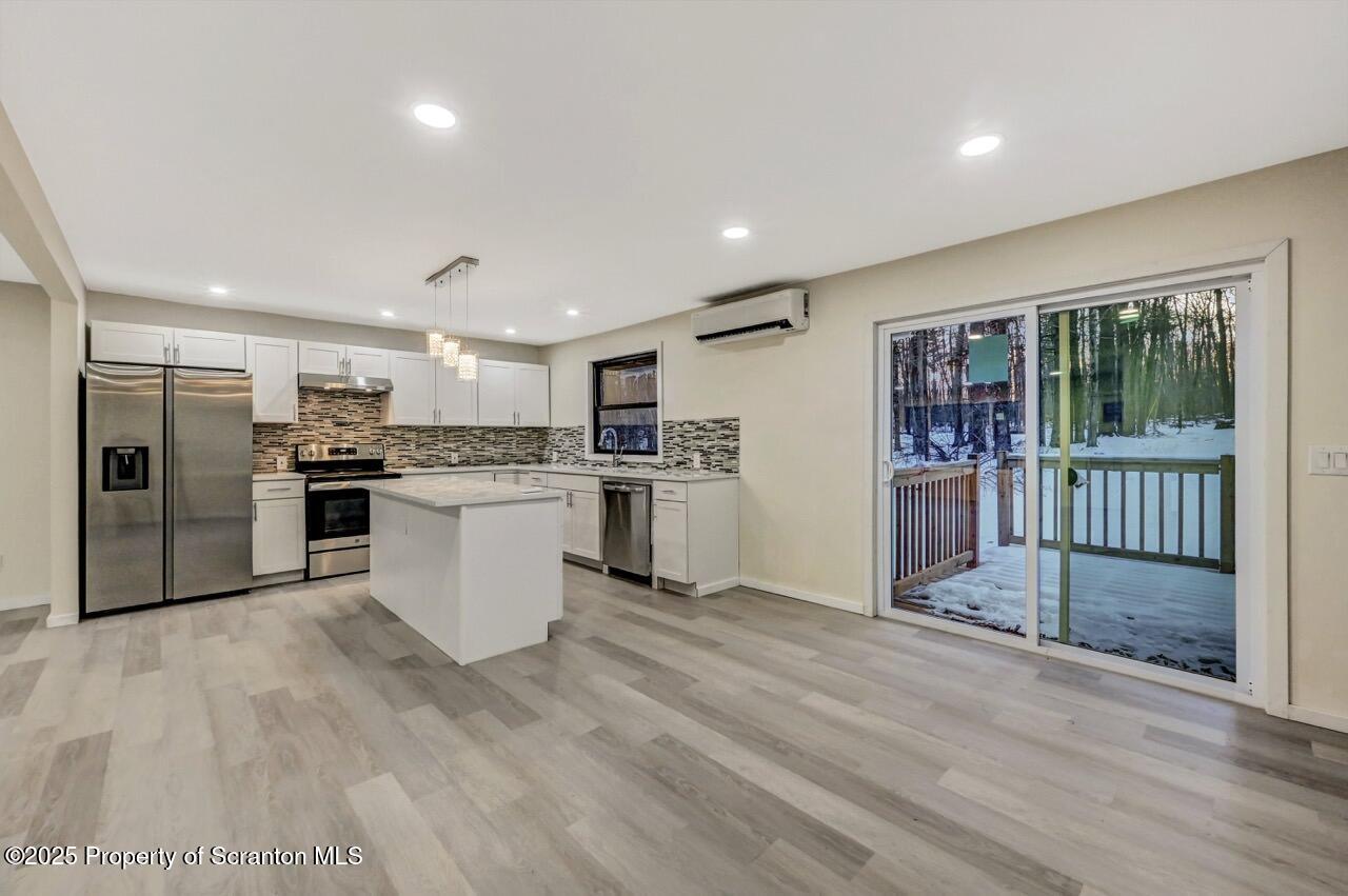 71 Sandy Beach Road Gouldsboro, PA 18424 - Photo 11 of 57 a kitchen with a refrigerator and a sink